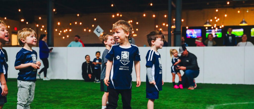 Smiling children on a soccer field