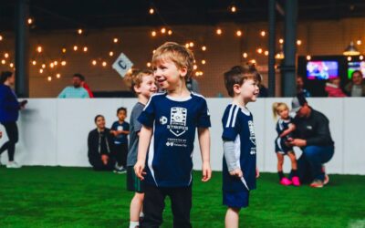 Smiling children on a soccer field